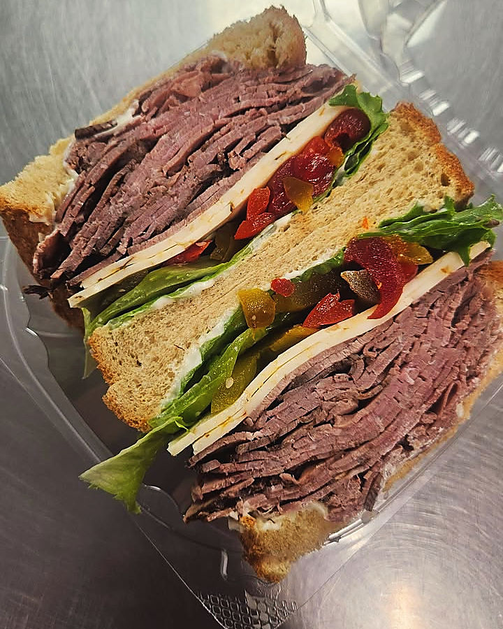 A roast beef sandwich, cut in half